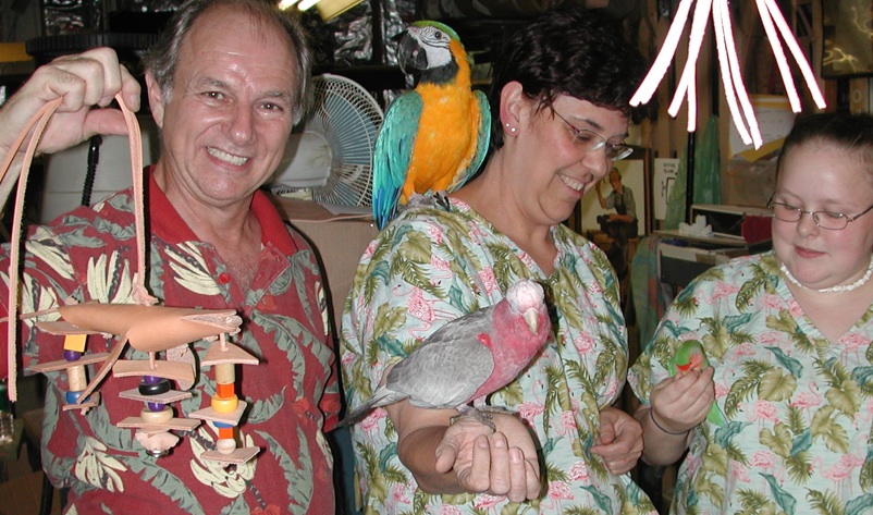 That's Rich Castano with a leather-and-beads bird toy and Rena Fox of Birds Supply of New Hamphire.